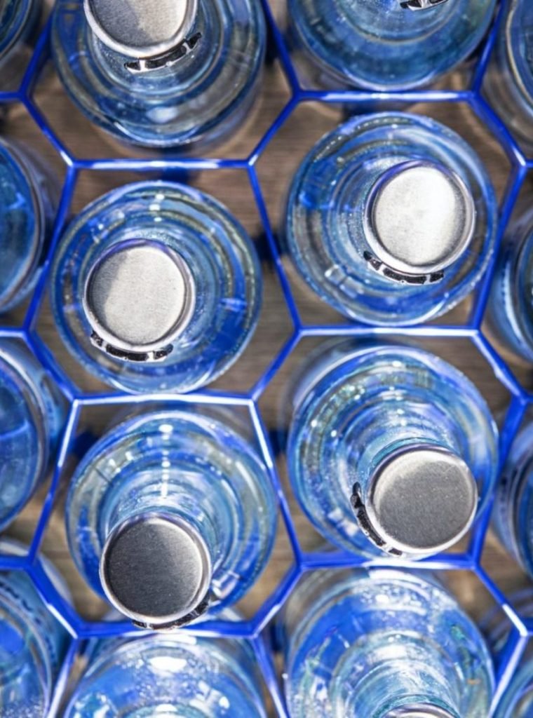 clear-glass-water-bottles-in-holders--e1635171648241.jpg